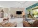 Bright living room featuring neutral decor, comfortable furniture, and access to the pool area at 213 Bayside Ct, Nokomis, FL 34275
