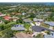 Aerial view of a quiet residential neighborhood with well-maintained homes, lush trees, and landscaping at 213 Bayside Ct, Nokomis, FL 34275