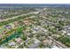 Aerial shot of a well-developed residential neighborhood with mature trees, and scenic ponds at 213 Bayside Ct, Nokomis, FL 34275