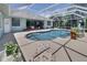 Enclosed pool featuring seamless deck, in-pool seating, and lush landscaping at 213 Bayside Ct, Nokomis, FL 34275