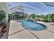 Beautiful screened-in pool offering a refreshing escape with ample seating and scenic backyard views at 213 Bayside Ct, Nokomis, FL 34275