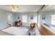 Light blue bedroom featuring wood-look flooring and charming white furniture set at 218 Palm Air Dr, Osprey, FL 34229