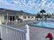 Beautiful pool, surrounded by tables and lounge chairs, for all of your relaxation needs at 218 Palm Air Dr, Osprey, FL 34229
