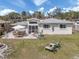 Wide aerial backyard with a patio, outdoor seating, and lush landscaping at 229 San Marco Dr, Venice, FL 34285