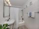 Bright bathroom featuring a bathtub with shower, white tile, and a pedestal sink at 229 San Marco Dr, Venice, FL 34285