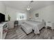 Comfortable bedroom with a ceiling fan, light-filled window, and stylish decor at 229 San Marco Dr, Venice, FL 34285