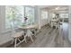Bright dining area with modern flooring, white furniture, and natural light from large windows at 229 San Marco Dr, Venice, FL 34285