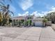 Charming single-Gathering home with a well-manicured lawn, tropical plants, and a two-car garage at 229 San Marco Dr, Venice, FL 34285