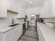 Clean, well-lit kitchen with white cabinets, updated appliances, and modern countertops at 229 San Marco Dr, Venice, FL 34285