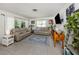 Bright living room featuring neutral furniture, a blue rug, and a wall-mounted TV at 229 San Marco Dr, Venice, FL 34285