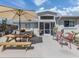 Outdoor patio with a picnic table, seating, and access to screened porch at 229 San Marco Dr, Venice, FL 34285