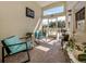 Relaxing sunroom with comfortable seating, plants, and access to the outdoors at 229 San Marco Dr, Venice, FL 34285