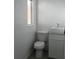 Bathroom features a toilet, sink with vanity, and a window for natural light at 231 Redwood Rd, Venice, FL 34293