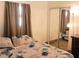 Comfortable bedroom features a decorative bedspread, sliding closet doors, and ample natural light at 231 Redwood Rd, Venice, FL 34293
