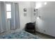 Bright bedroom with colorful bedding, a chair, and natural light from a window at 231 Redwood Rd, Venice, FL 34293
