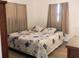 Comfortable bedroom with a queen-sized bed, decorative bedding, and warm, natural light at 231 Redwood Rd, Venice, FL 34293