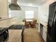 Bright dining area adjacent to the kitchen, with a table and comfortable wicker chairs at 231 Redwood Rd, Venice, FL 34293