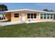 Charming single-story home with a well-manicured lawn, covered carport and clean landscaping at 231 Redwood Rd, Venice, FL 34293