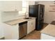 Modern kitchen featuring granite countertops, stainless steel appliances, and ample natural light at 231 Redwood Rd, Venice, FL 34293