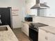 Well-equipped kitchen featuring stainless steel appliances and attractive granite countertops at 231 Redwood Rd, Venice, FL 34293