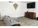 Cozy living room features a couch, flat screen television, and tile flooring at 231 Redwood Rd, Venice, FL 34293