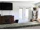 Comfortable living room featuring tile flooring, a media center, and french doors that bring in natural light at 231 Redwood Rd, Venice, FL 34293