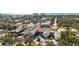 Aerial view of complex and neighborhood with beautiful trees and landscaping on a sunny day at 236 Harbor S Dr # 202, Venice, FL 34285