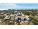 An aerial view capturing the neighborhood streets and houses, with lush trees and the beautiful beach in the background at 236 Harbor S Dr # 202, Venice, FL 34285
