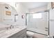 Updated bathroom featuring a marble vanity, sleek fixtures, and a glass-enclosed shower over tub at 236 Harbor S Dr # 202, Venice, FL 34285