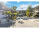 Landscaped courtyard featuring tropical plants, providing a serene and inviting space for residents of the condo community at 236 Harbor S Dr # 202, Venice, FL 34285