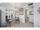 Dining area with unique mirrored wall decor and a view of the adjacent bathroom in this stylish condo unit at 236 Harbor S Dr # 202, Venice, FL 34285
