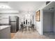 Cozy dining area with a glass table, seating for two, and a modern stainless steel refrigerator at 236 Harbor S Dr # 202, Venice, FL 34285