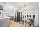 Efficient kitchenette with stainless steel refrigerator, modern fixtures, and sunlit breakfast nook at 236 Harbor S Dr # 202, Venice, FL 34285