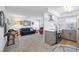 Open-concept living room and kitchen with modern appliances, seamlessly connected in this updated condo unit at 236 Harbor S Dr # 202, Venice, FL 34285