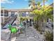Cozy patio with outdoor seating, surrounded by tropical landscaping, perfect for relaxing in this condo community at 236 Harbor S Dr # 202, Venice, FL 34285