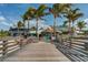 Sharky's restaurant with beachfront views framed by palm trees, accessible by a wooden boardwalk at 236 Harbor S Dr # 202, Venice, FL 34285