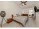 Cozy bedroom with a queen bed, wood floors, ceiling fan, and a peaceful backyard view at 268 Southampton Dr # 309, Venice, FL 34293