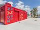 A vibrant red building with unique artwork offers a distinctive and modern architectural design at 268 Southampton Dr # 309, Venice, FL 34293