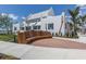Attractive white building with palm trees around the corner, complemented by well-maintained landscaping at 268 Southampton Dr # 309, Venice, FL 34293