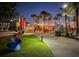 Vibrant outdoor space with an array of food kiosks and seating areas, lit by string lights at night at 268 Southampton Dr # 309, Venice, FL 34293