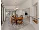 Bright dining room features a modern chandelier, a neutral rug, and large windows overlooking the backyard at 268 Southampton Dr # 309, Venice, FL 34293