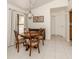 Dining area with backyard views, decorative light fixture and room to accommodate four chairs at 268 Southampton Dr # 309, Venice, FL 34293