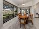 Dining room with a view of the water features large windows for natural light, and modern chandelier at 268 Southampton Dr # 309, Venice, FL 34293