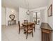 Inviting dining area featuring a round wood table, pendant lighting, and backyard views at 268 Southampton Dr # 309, Venice, FL 34293