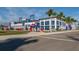 Modern baseball stadium exterior with large signage, palm trees, and vibrant landscaping at 268 Southampton Dr # 309, Venice, FL 34293