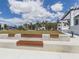 Inviting outdoor space with multiple seating areas and view of lush green lawn and community buildings at 268 Southampton Dr # 309, Venice, FL 34293