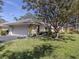 Charming single-story home with a well-manicured lawn and mature tree in the front yard at 268 Southampton Dr # 309, Venice, FL 34293