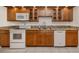 Functional kitchen features white appliances, granite countertops, and ample cabinet space at 268 Southampton Dr # 309, Venice, FL 34293