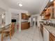 Spacious kitchen featuring granite counters, wooden cabinets, and white appliances and tile flooring at 268 Southampton Dr # 309, Venice, FL 34293