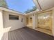 Private outdoor patio with wood deck flooring, secure gate, and access to home at 268 Southampton Dr # 309, Venice, FL 34293